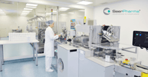GMP-operator-working-on-packaging-line-at-a-distance