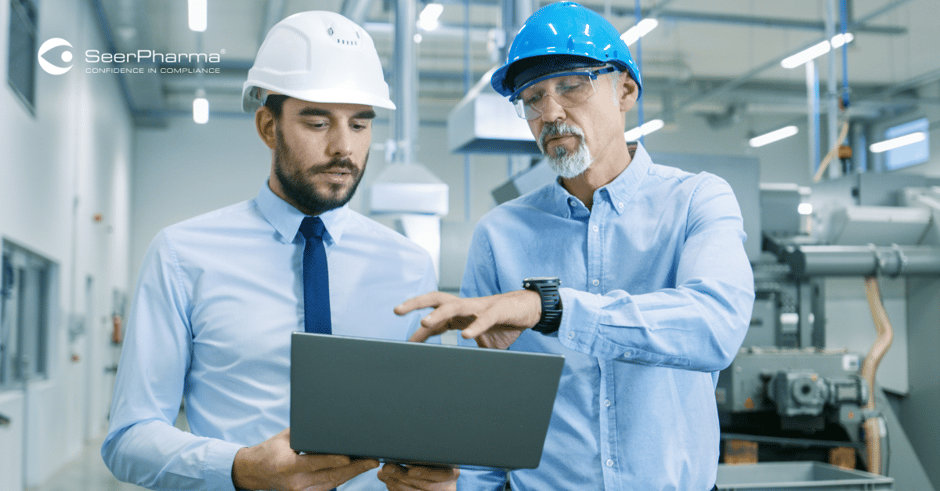Head of the Project Holds Laptop and Discusses Product Details with Chief Engineer while They Walk Through Modern Factory