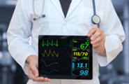 Doctor with ECG on tablet device cropped