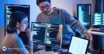 2 people working on computer system development process workflow
