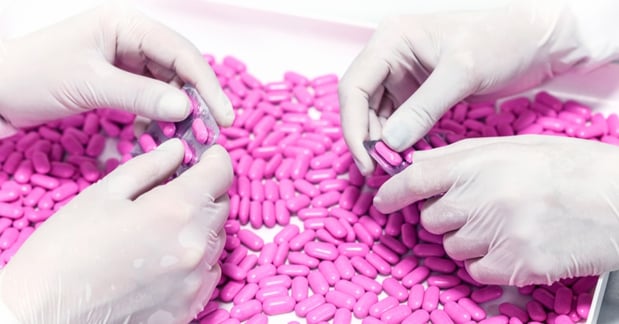 gloved-GMP-operators-removing-tablets-from-blisters
