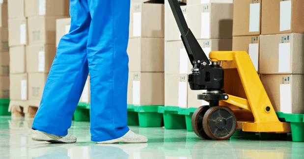 GMP Operator working pallet trolley in a GMP warehouse